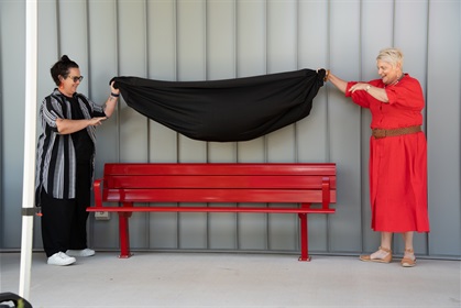 Councillor Mellissa Holzheimer and Councillor Leanne Patrick revealing a new red bench located at the Philip Street Communities and Families Precinct 