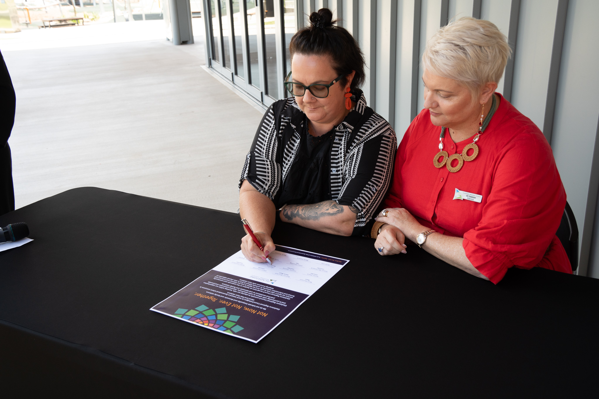 Councillors sitting and signing pledge 