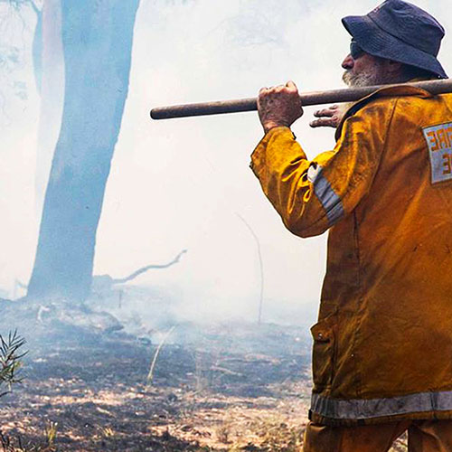 Rural Fire person in smokey paddock Hero Tile