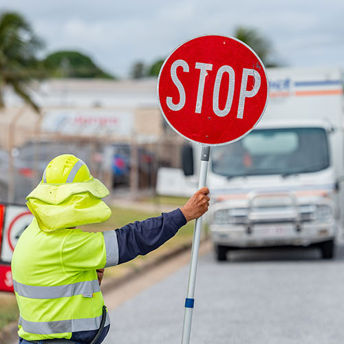 GRC worker holding stop sign at road works