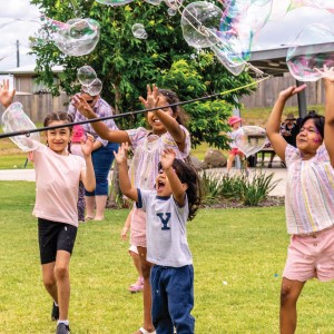 Kids playing with bubbles at Philip St